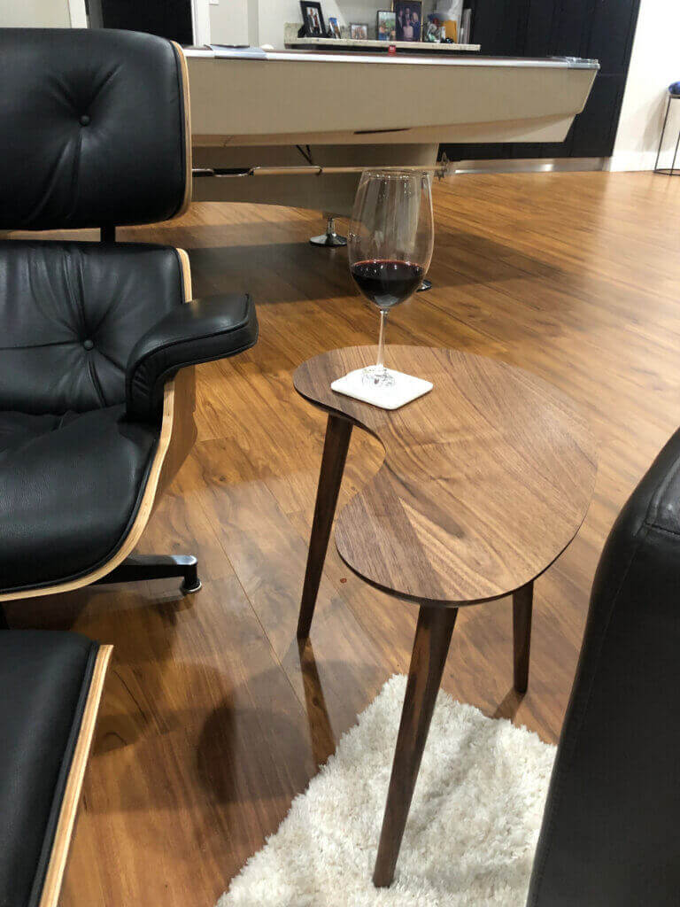 Kidney Bean Side Table Small next to Eames Chair with Black Leather, walnut shell.